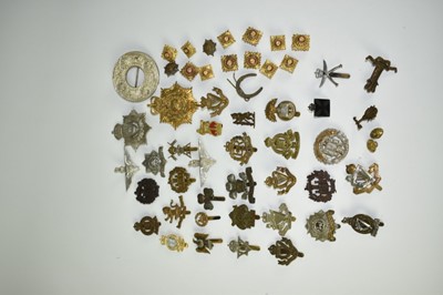 Lot 727 - Collection of thirty plus military cap badges and pips to include Royal Marines, Army Chaplins badge, Essex Regiment Wartime economy badge and others (Qty)
