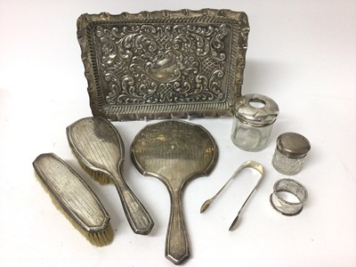 Lot 329 - Edwardian silver dressing table tray of rectangular form with embossed decoration, (Birmingham 1909), together with a silver backed hand mirror.