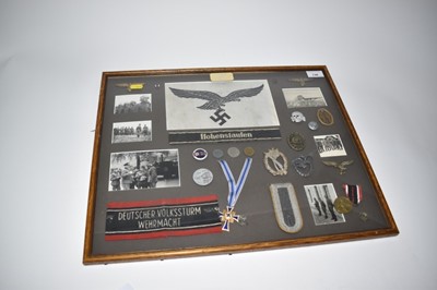 Lot 736 - Group of Second World War Nazi badges and decorations to include Nazi Mothers Cross, Nazi wound badge and Luftwaffe cap badge, mounted in a glazed frame with reproduction photographs. N.B. Nazi dec...