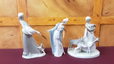 Lot 1329 - Seven Lladro figures including lady with goats, girls with flowers etc, together with a Nao figure and a Coalbrookdale Coalport floral encrusted lidded pot (9)