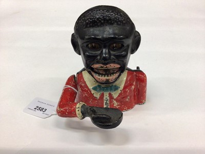 Lot 2583 - Early 20th century cast iron mechanical money bank “Gentleman in a red jacket and yellow bow tie” with moveable arm, tongue and eyes. 16.5cm overall height. Base plate plug absent. Together another...