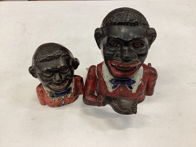 Lot 2584 - Early 20th century cast iron money bank “Gentleman in a red jacket and dark blue bow tie” with moveable arm, eyes and tongue, together with one smaller, larger money bank 16.5cm overall height. (2)