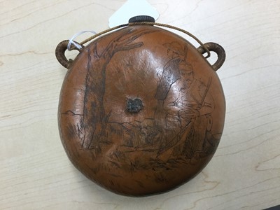 Lot 1014 - 19th century spirit flask made from a gourd with metal mounted cork and woven suspension loops, the surface decorated with scratch engraved floral design and scene of bandits with a dog, signed Aja...
