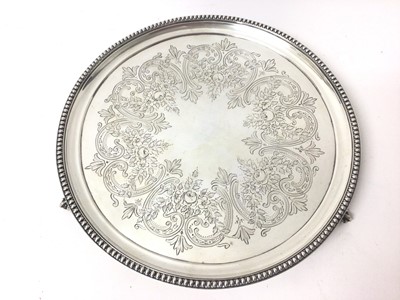 Lot 326 - Victorian silver salver of circular form with engraved decoration and beaded border, raised on three claw and ball feet, (London 1873), maker Henry Holland, 19ozs 25.5cm in diameter