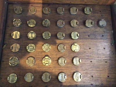 Lot 2024 - Display of vintage brass petrol can lids