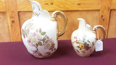 Lot 1362 - Royal Worcester porcelain ewer with gilt rim and handle and floral decoration, 22.5cm high, together with a smaller ewer, 15.5cm high