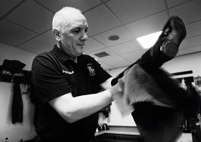 Lot 23 - Jayne Odell black and white photographic print, 'The valet - polishing boots', 100cm x 71cm