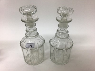 Lot 1374 - Pair of 19th century glass decanters with triple ring necks and mushroom stoppers, together with another similar (3)