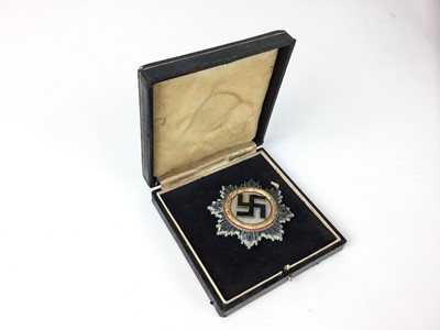 Lot 839 - Good Post War copy of a Nazi German Cross in gold, the pin stamped with a 1, in case.
