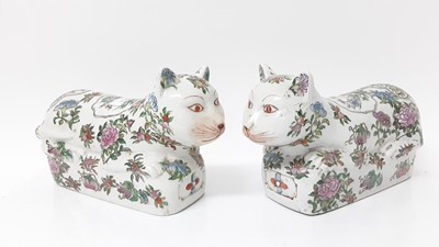 Lot 1383 - Large pair of Chinese famille rose porcelain models of cats, 20th century, painted with flowers, seal marks to bases, 31cm long