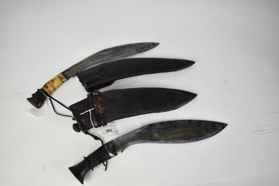 Lot 963 - Two late 19th/ early 20th century Kukris , one with horn hilt, both with leather covered sheaths (2)