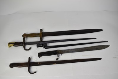 Lot 978 - First World War German butcher bayonet, French Gras bayonet, Turkish Mauser bayonet, Russian socket bayonet and French Gladius sidearm (5)