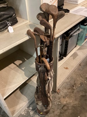 Lot 2559 - Set of early 20th century golf clubs in leather and canvas bag.