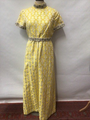 Lot 2142 - 1970's clothing including gold and yellow beaded brocade hostess dress, cream chiffon hostess dress, two fancy white cotton blouses, one by Laura Ashley, long fine wool cloak with hood and tassel,...