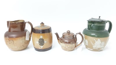 Lot 1395 - Doulton Lambeth stoneware jar and cover, together with two jugs decorated with hunting, drinking and smoking scenes and a small teapot (4)