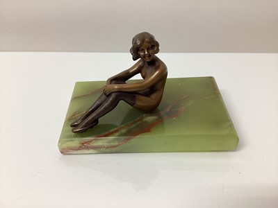 Lot 2612 - Art Deco bronze figure of a seated nude woman in stockings, on a green onyx base, 12.5cm in length.
