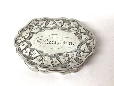 Lot 316 - Victorian silver vinaigrette of oval form with engraved leaf decoration and naming to hinged cover, pierced grill to interior (Birmingham 1888), maker George Unite, 4.5cm in length.