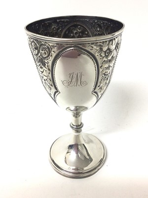Lot 328 - Victorian silver goblet of conventional form with border of embossed floral decoration, and engraved initial, (Sheffield 1869), maker Fenton Brothers, all at 5.5ozs, 16.5cm in height.
