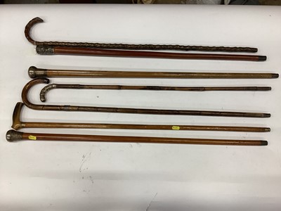 Lot 2664 - Three Victorian silver mounted walking sticks, Indian white metal mounted walking stick with figure decoration and three other walking sticks (6)
