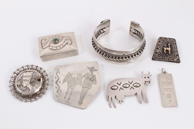 Lot 294 - Egyptian silver brooch, Mexican silver brooch and trinket box, silver cow brooch, silver ingot pendant, Peruvian silver brooch with applied 18ct gold llama decoration and a silver torque bangle