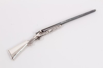 Lot 381 - Contemporary silver miniature model of a side by side shotgun with working loading action