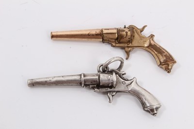 Lot 382 - Antique white metal novelty watch winding key in the form of a revolver, together with a similar gold plated revolver