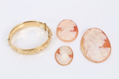 Lot 391 - Gold plated bangle and three carved shell cameos depicting female busts
