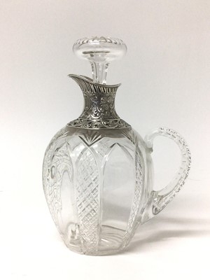Lot 194 - Edwardian silver mounted cut glass claret jug with embossed and pierced silver spout and collar, the ovoid body with diamond cut decoration. Birmingham 1905. Height 22cm.