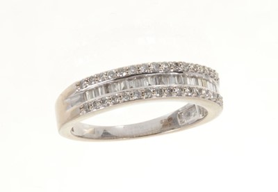 Lot 495 - Diamond ring with a band of baguette cut diamonds flanked by a border of brilliant cut diamonds in 18ct white gold setting