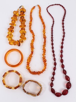 Lot 856 - Amber bead necklace, one other necklace, vintage simulated cherry amber faceted bead necklace and three bracelets