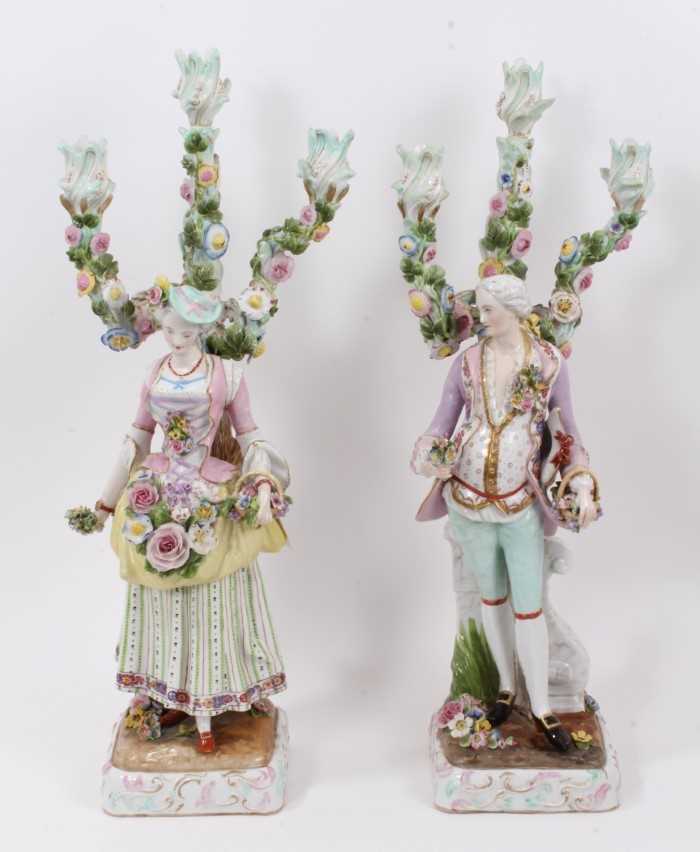 Lot 22 - Pair of Meissen style porcelain figural candlesticks