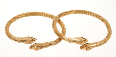 Lot 447 - Pair of eastern yellow metal snake bangles