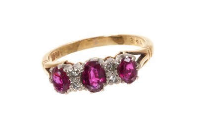 Lot 445 - Ruby and diamond ring with three oval mixed cut rubies and four single cut diamonds in gold claw setting on 18ct yellow gold shank