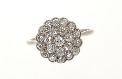 Lot 425 - Antique diamond cluster ring with a flower head cluster of pavé set old cut diamonds in platinum setting