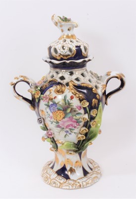 Lot 86 - An Imperial Russian Garner Factory porcelain lidded vase, circa 1900, with pierced decoration and hand painted central panels with individual applied flowers, blue mark to base, 39cm tall