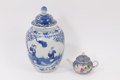 Lot 45 - A 19th century Chinese blue and white porcelain vase and cover, decorated with figural scenes, 23cm high, together with a miniature 19th century Chinese famille rose teapot, 7.5cm high