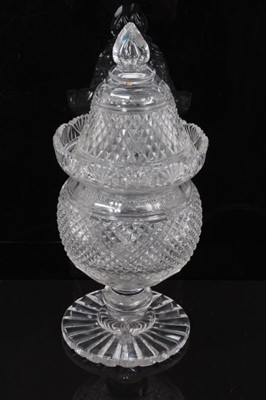 Lot 67 - A large 19th century cut glass covered vase/bonbonniere, diamond and facet cut, the rim with fan-shaped pattern, on knopped stem and circular base, 32cm high