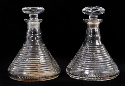 Lot 69 - A near pair of 19th century cut glass ship's decanters, with banded decoration to the bodies, 23cm high