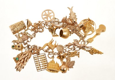 Lot 415 - 9ct gold charm bracelet with a collection of twenty-six various carat gold and yellow metal charms