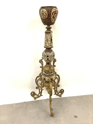 Lot 88 - A 19th century continental pottery and brass jardinière on stand, possibly Austrian, decorated with foliate patterns and cherubs in shades of brown and blue, standing on three scrolled brass legs,...