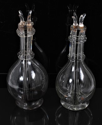 Lot 94 - An unusual pair of French glass decanters, each internally divided into four parts, with individual stoppers, 31cm high