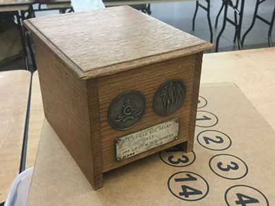 Lot 139 - 1930's Oak cigarette box / dispenser with applied silver plaque and Royal Artillery badge.
