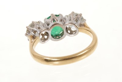 Lot 472 - Emerald and diamond three stone ring with a round mixed cut emerald estimated to weigh approximately 0.85cts flanked by two round brilliant cut diamonds, all in claw setting on 18ct gold shank. Est...