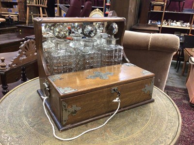 Lot 119 - Edwardian oak three-bottle tantalus with silver plated mounts and cigar drawer (key present), 34cm wide