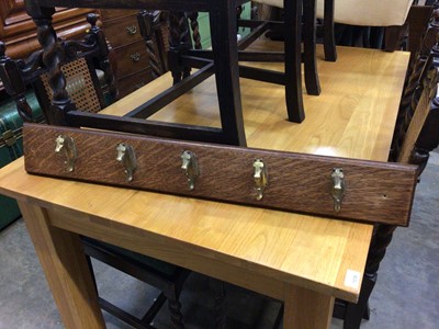 Lot 128 - Early 20th century oak coat rail with brass horse head hooks, 90cm long