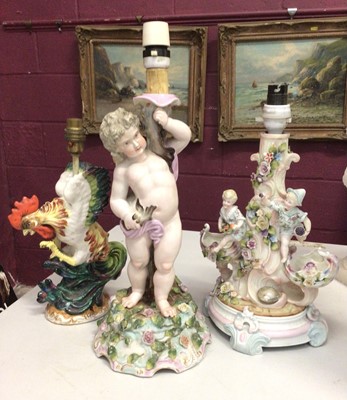 Lot 307 - 19th century Dresden Cupid table lamp, Continental figure lamp and a cockerel lamp (3)