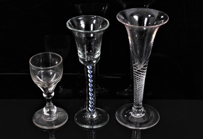 Lot 143 - Georgian air twist wine glass with trumpet bowl, together with a Continental wine glass with blue and white spiral twist stem and another small glass (3)