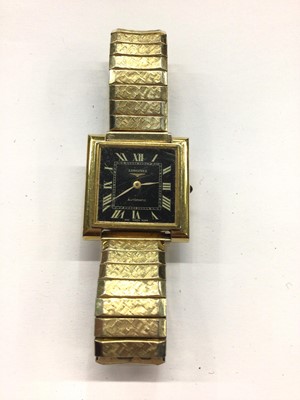 Lot 829 - 1970s Longines gold plated automatic wristwatch with black square dial and Roman numeral markers