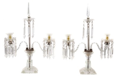 Lot 883 - Impressive pair of Regency style twin branch glass candlesticks, each hung with prismatic glass drops raised on square base, 63cm high