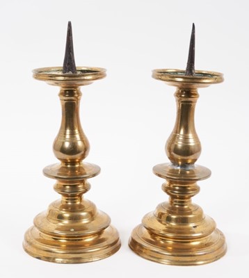 Lot 895 - Pair of 17th century brass pricket candlesticks
